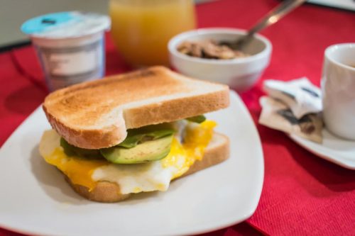 Detail of breakfast toast with avocado and scrambled egg